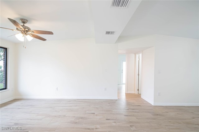 unfurnished room featuring baseboards, visible vents, light wood-style floors, and a ceiling fan