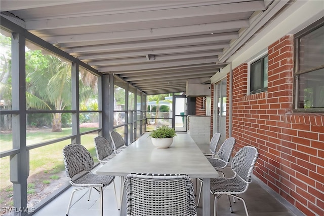 unfurnished sunroom with outdoor dining space