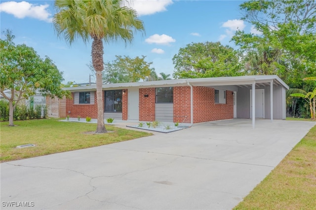 ranch-style home featuring driveway, a front yard, an attached carport, and brick siding