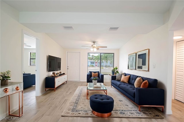 living area featuring visible vents, light wood-style flooring, and a ceiling fan