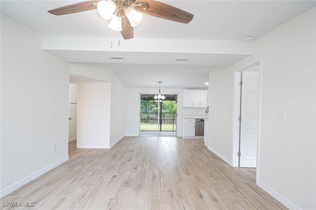 unfurnished living room featuring ceiling fan with notable chandelier, baseboards, light wood-style floors, and visible vents