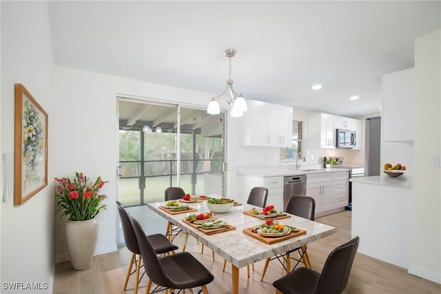 dining room featuring light wood-style flooring and recessed lighting