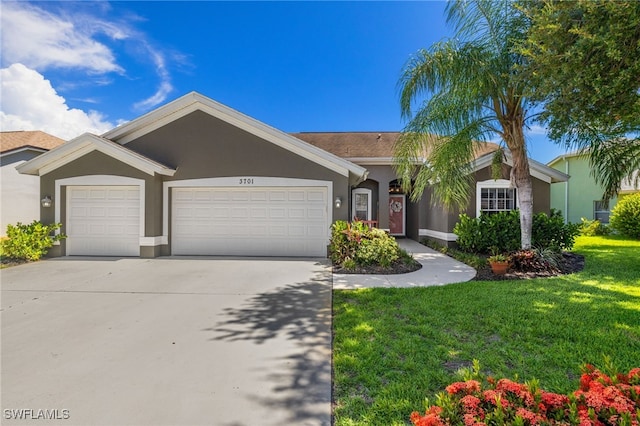 3701 Bali Ln, Estero, FL 33928 - ranch-style home with a front yard, stucco siding, concrete driveway, and a garage