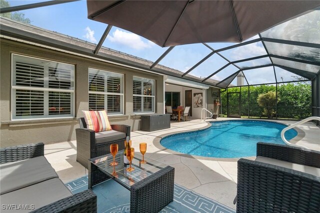 3701 Bali Ln, Estero, FL 33928 - pool with glass enclosure, an outdoor hangout area, and a patio