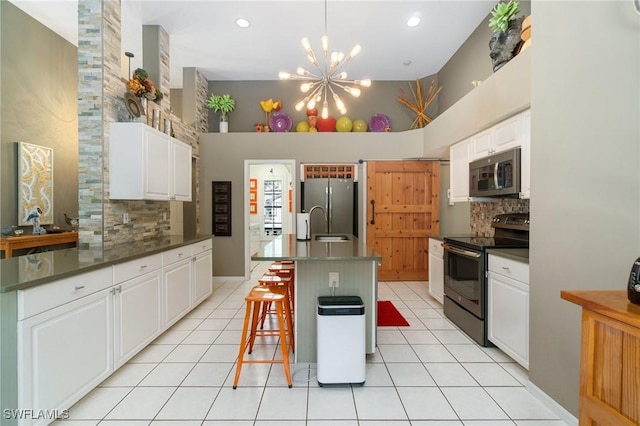 3701 Bali Ln, Estero, FL 33928 - kitchen featuring decorative backsplash, light tile patterned floors, stainless steel appliances, dark countertops, and a notable chandelier