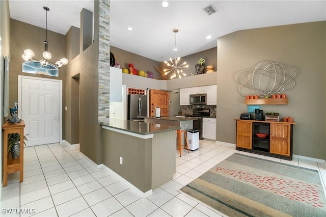 3701 Bali Ln, Estero, FL 33928 - kitchen with an inviting chandelier, stainless steel appliances, dark countertops, visible vents, and a peninsula