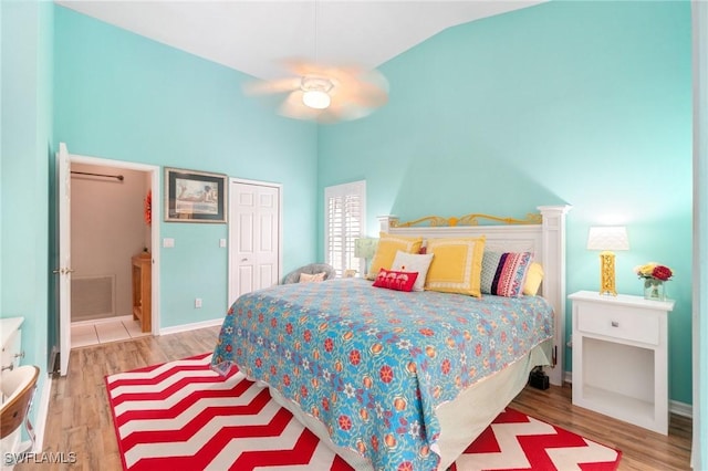 3701 Bali Ln, Estero, FL 33928 - bedroom featuring a closet, baseboards, lofted ceiling, and wood finished floors