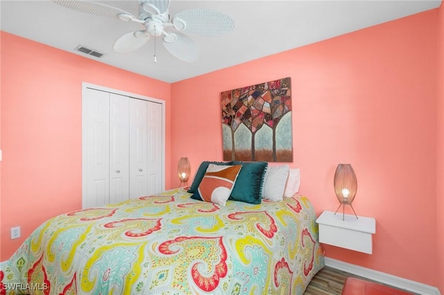 3701 Bali Ln, Estero, FL 33928 - bedroom featuring a closet, a ceiling fan, wood finished floors, baseboards, and visible vents