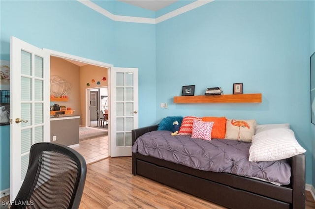 3701 Bali Ln, Estero, FL 33928 - bedroom featuring a high ceiling, wood finished floors, and french doors