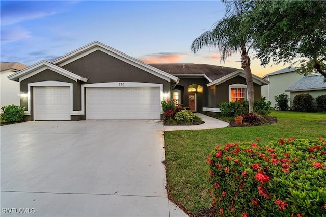 3701 Bali Ln, Estero, FL 33928 - ranch-style house featuring stucco siding, an attached garage, a lawn, and concrete driveway