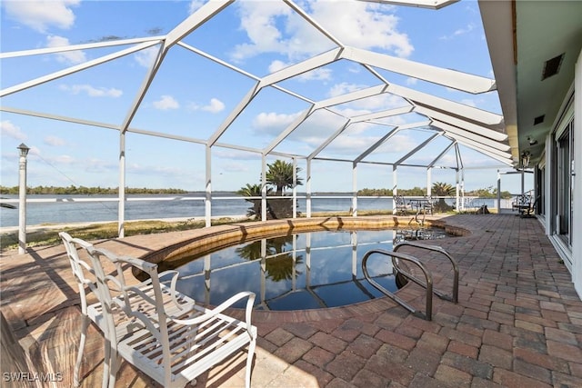11915 Island Ave, Matlacha, FL 33993 - view of patio / terrace featuring a lanai, an outdoor pool, a water view, and visible vents