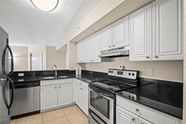 8245 Ibis Club Dr Unit 401, Naples, FL 34104 - kitchen with stainless steel appliances, under cabinet range hood, a sink, light tile patterned flooring, and white cabinets