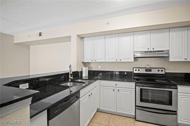 8245 Ibis Club Dr Unit 401, Naples, FL 34104 - kitchen with stainless steel appliances, dark stone countertops, under cabinet range hood, a sink, and visible vents