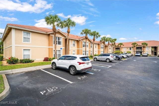8245 Ibis Club Dr Unit 401, Naples, FL 34104 - uncovered parking lot with a residential view