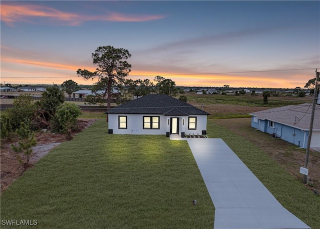 9007 E Crow Cir, Labelle, FL 33935 - view of front facade with a front lawn and driveway