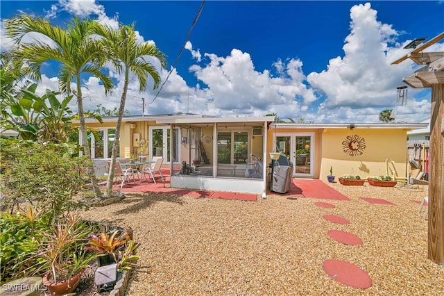 231 Kingston Dr, Fort Myers, FL 33905 - back of house with stucco siding, a patio area, a sunroom, and french doors