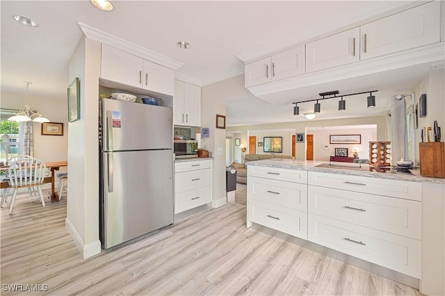 231 Kingston Dr, Fort Myers, FL 33905 - kitchen with freestanding refrigerator, open floor plan, white cabinetry, light wood finished floors, and track lighting
