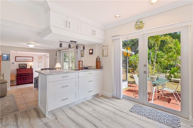 231 Kingston Dr, Fort Myers, FL 33905 - kitchen with french doors, a peninsula, white cabinetry, plenty of natural light, and crown molding