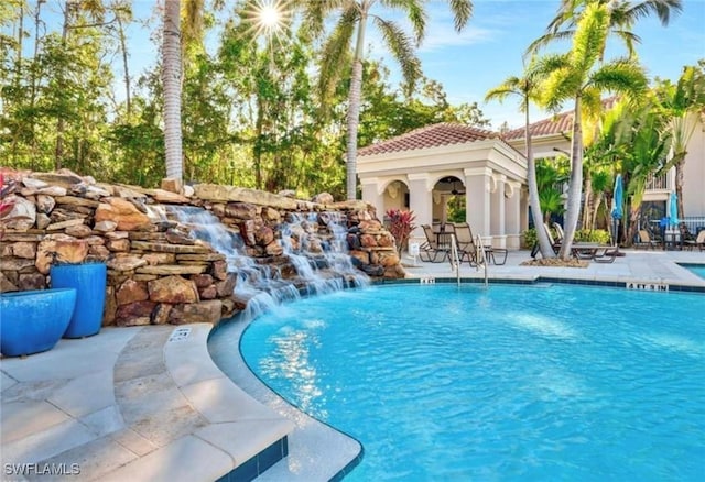 8521 Violeta St Unit 101, Estero, FL 34135 - community pool featuring a patio and an outdoor structure