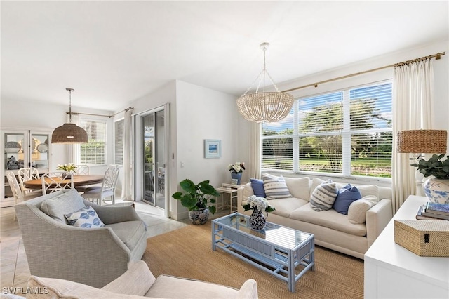 living area featuring light tile patterned flooring, a chandelier, and a healthy amount of sunlight