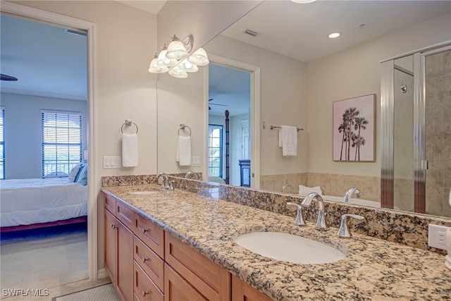 bathroom featuring a ceiling fan, a sink, ensuite bath, and visible vents