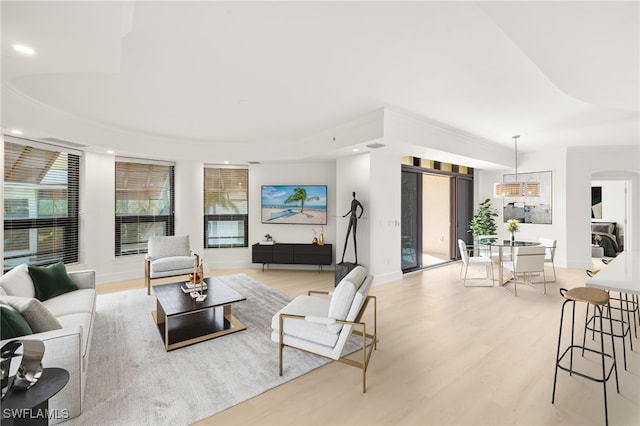 9123 Strada Pl Unit 7316, Naples, FL 34108 - living area with light wood finished floors, recessed lighting, baseboards, arched walkways, and plenty of natural light