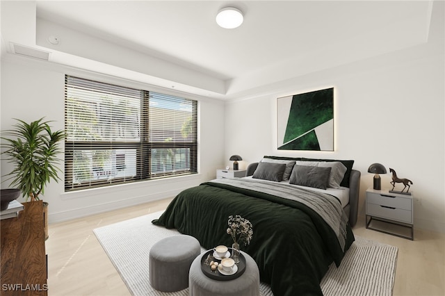 9123 Strada Pl Unit 7316, Naples, FL 34108 - bedroom with multiple windows, a tray ceiling, and baseboards
