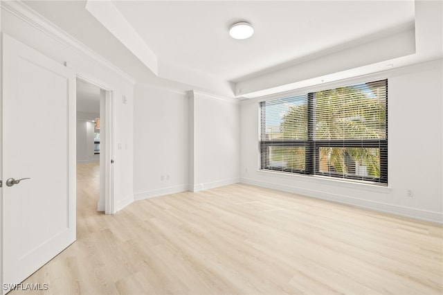 9123 Strada Pl Unit 7316, Naples, FL 34108 - spare room featuring a tray ceiling, light wood-style flooring, and baseboards