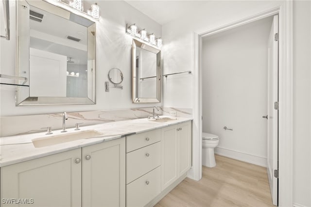 9123 Strada Pl Unit 7316, Naples, FL 34108 - full bath with toilet, wood finished floors, double vanity, and baseboards
