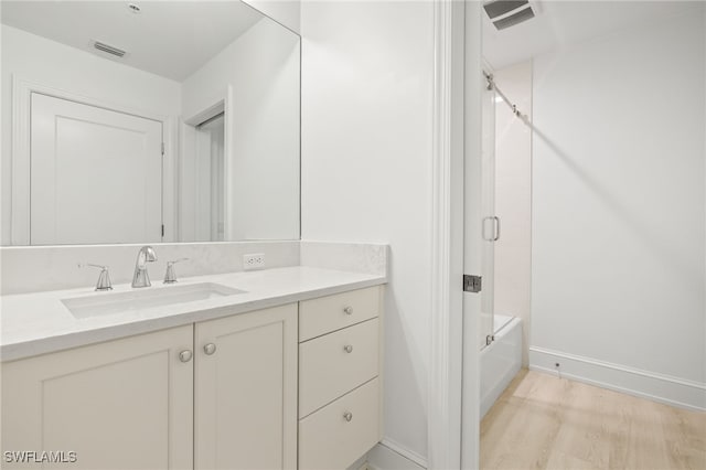 9123 Strada Pl Unit 7316, Naples, FL 34108 - bathroom featuring wood finished floors, shower / bath combination, vanity, and baseboards
