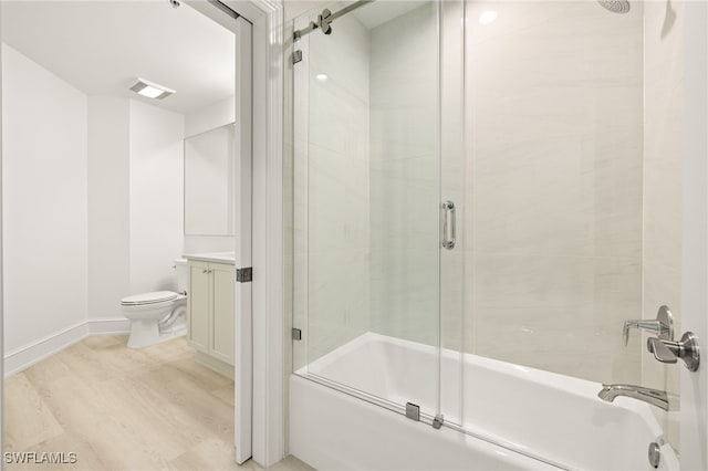 9123 Strada Pl Unit 7316, Naples, FL 34108 - bathroom with combined bath / shower with glass door, wood finished floors, toilet, baseboards, and vanity