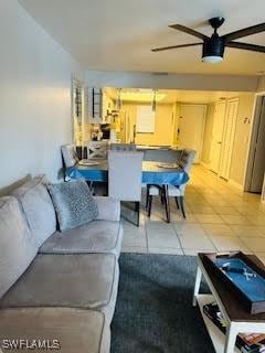 living area with light tile patterned flooring and ceiling fan
