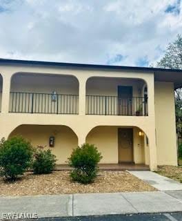 view of front of property featuring a balcony and stucco siding