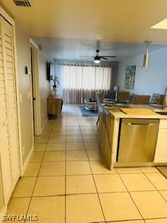 kitchen featuring stainless steel dishwasher, light tile patterned flooring, visible vents, and a ceiling fan