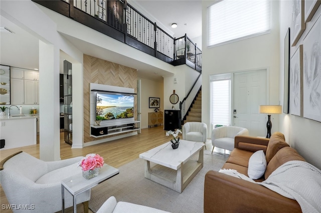 10327 Carolina Willow Dr, Fort Myers, FL 33913 - living area with a high ceiling, stairway, and light wood-type flooring