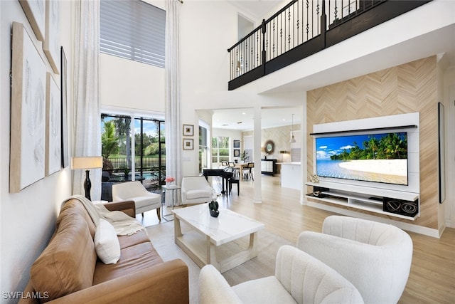 10327 Carolina Willow Dr, Fort Myers, FL 33913 - living room featuring a towering ceiling, wood finished floors, and baseboards