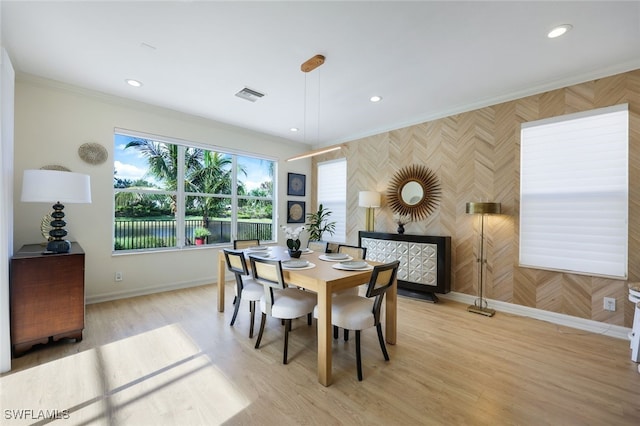 10327 Carolina Willow Dr, Fort Myers, FL 33913 - dining area with baseboards, recessed lighting, crown molding, light wood-type flooring, and an accent wall
