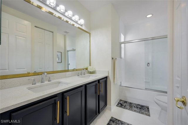 10327 Carolina Willow Dr, Fort Myers, FL 33913 - bathroom featuring toilet, double vanity, tile patterned floors, and bath / shower combo with glass door