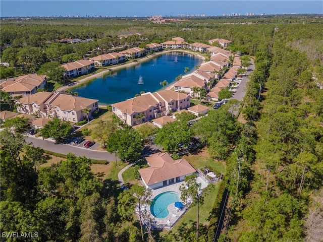 aerial view featuring a water view, a residential view, and a forest view