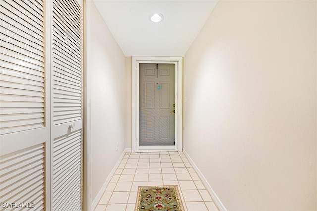 9648 Windsor Gardens Ln Unit 104, Fort Myers, FL 33919 - doorway featuring light tile patterned flooring and baseboards