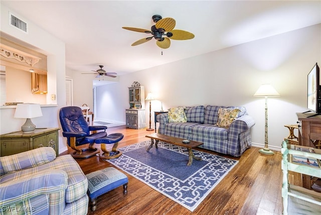 9648 Windsor Gardens Ln Unit 104, Fort Myers, FL 33919 - living area featuring a ceiling fan, wood finished floors, and baseboards