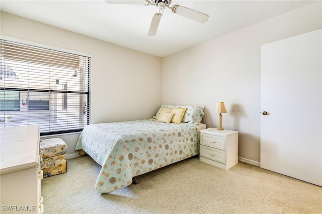 9648 Windsor Gardens Ln Unit 104, Fort Myers, FL 33919 - bedroom featuring light carpet, baseboards, and a ceiling fan