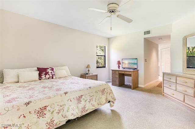 9648 Windsor Gardens Ln Unit 104, Fort Myers, FL 33919 - bedroom with light carpet, baseboards, and a ceiling fan