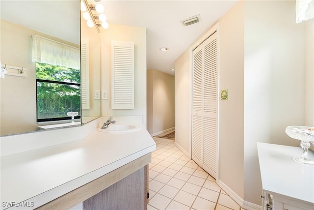 9648 Windsor Gardens Ln Unit 104, Fort Myers, FL 33919 - bathroom with a closet, vanity, tile patterned flooring, baseboards, and recessed lighting