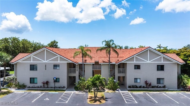 9648 Windsor Gardens Ln Unit 104, Fort Myers, FL 33919 - view of building exterior with uncovered parking
