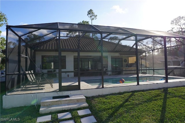 3393 21st Ave SW, Naples, FL 34117 - back of house with an outdoor pool, glass enclosure, and a patio area