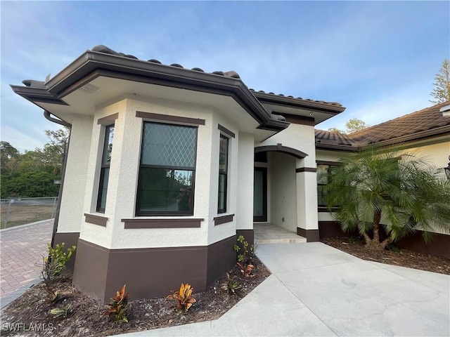 3393 21st Ave SW, Naples, FL 34117 - view of home's exterior with stucco siding and a tile roof