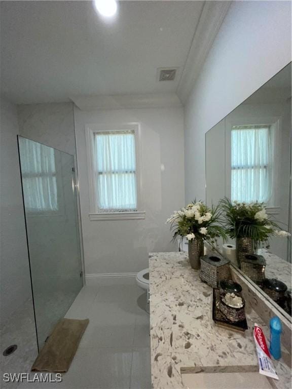 3393 21st Ave SW, Naples, FL 34117 - bathroom featuring a shower stall, vanity, toilet, visible vents, and plenty of natural light