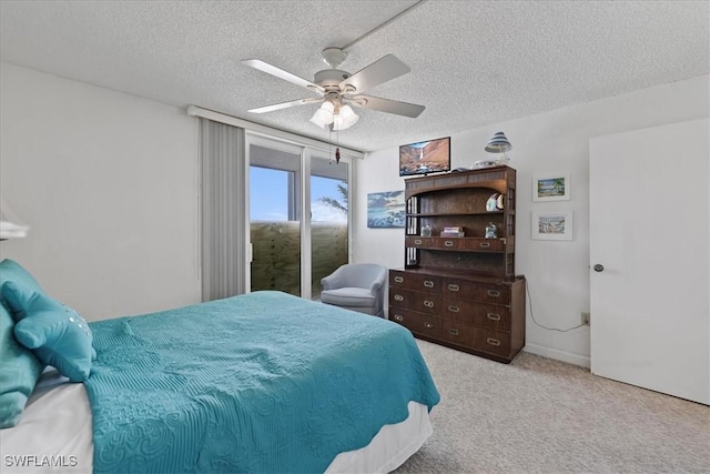7148 Estero Blvd Unit 423, Fort Myers Beach, FL 33931 - carpeted bedroom featuring access to outside, a ceiling fan, and a textured ceiling