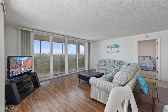 living area with floor to ceiling windows, wood finished floors, and a textured ceiling
